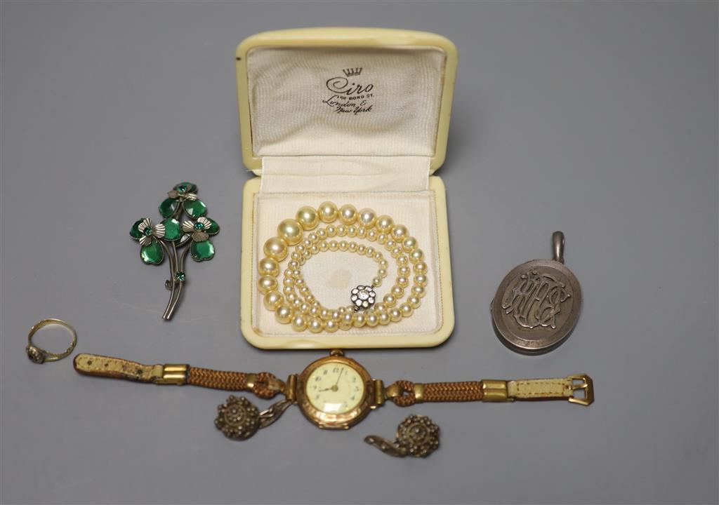 A ladys 585 yellow metal manual wind wrist watch, gross 23.2 grams, a white metal locket and other minor jewellery.